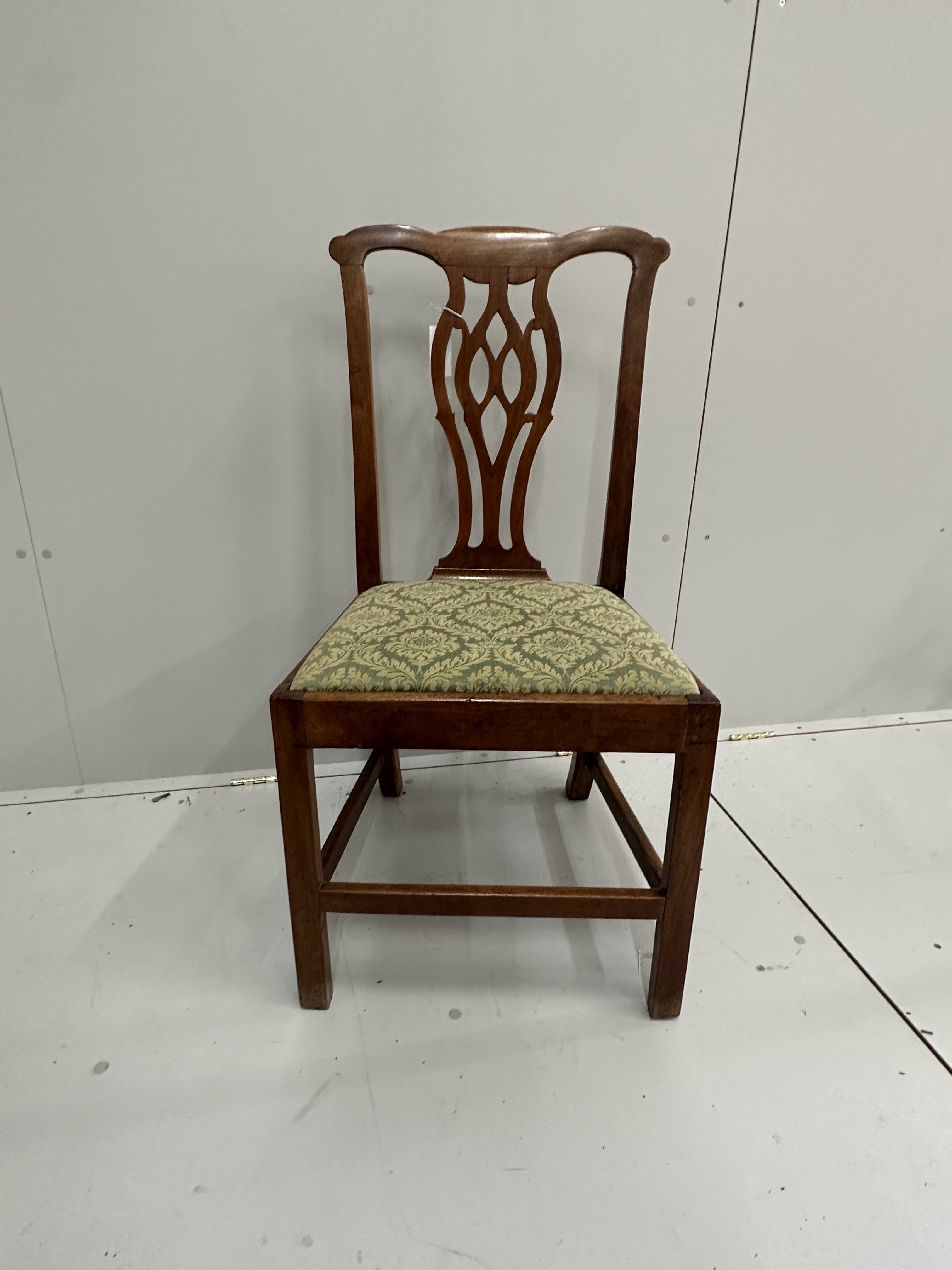 A pair of Chippendale style walnut dining chairs with drop in seats, an 18th century style walnut footstool and a pair of Victorian brass chestnut roasters